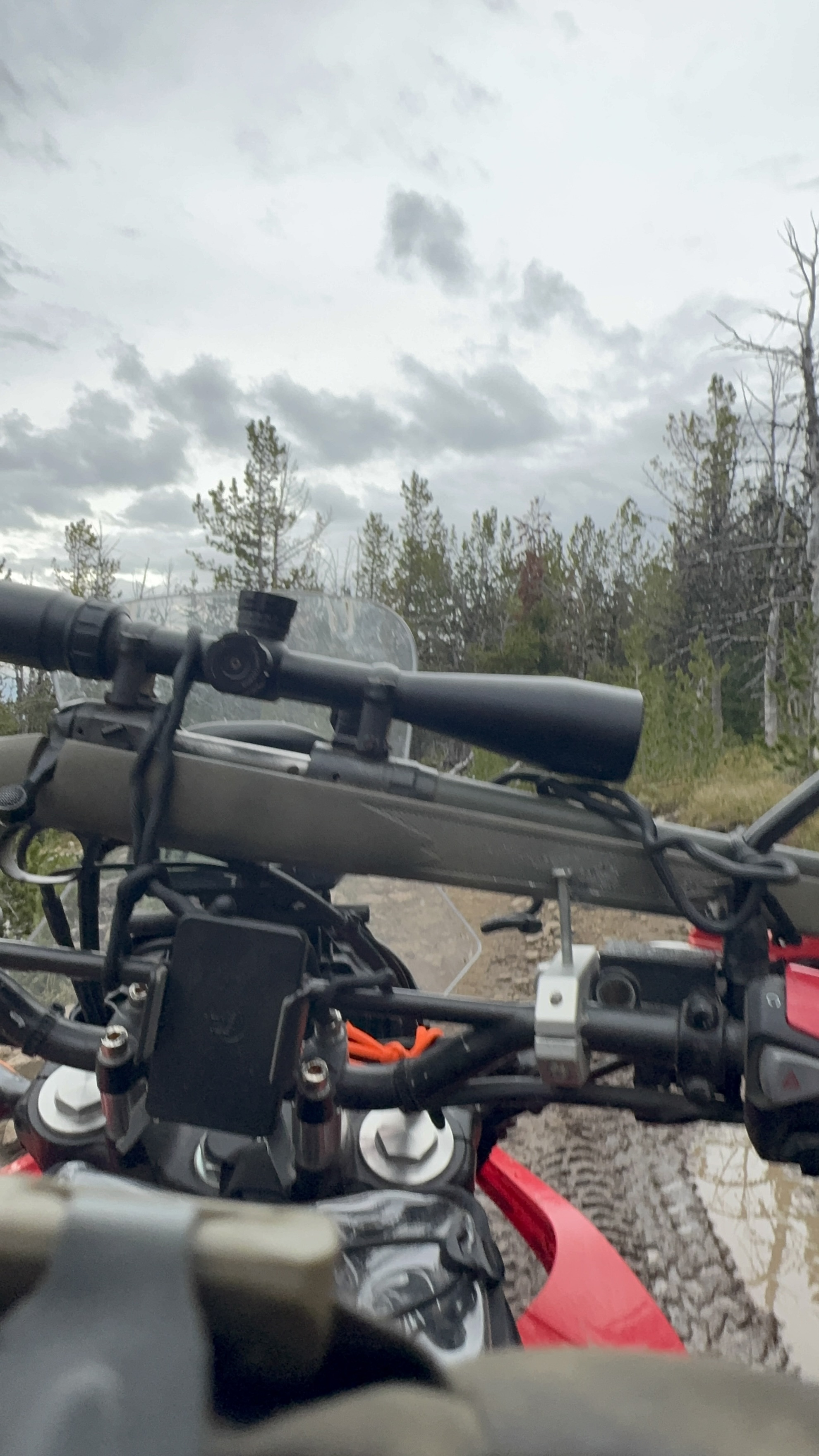 Loaded adventure motorcycles and hunting gear in the backcountry
